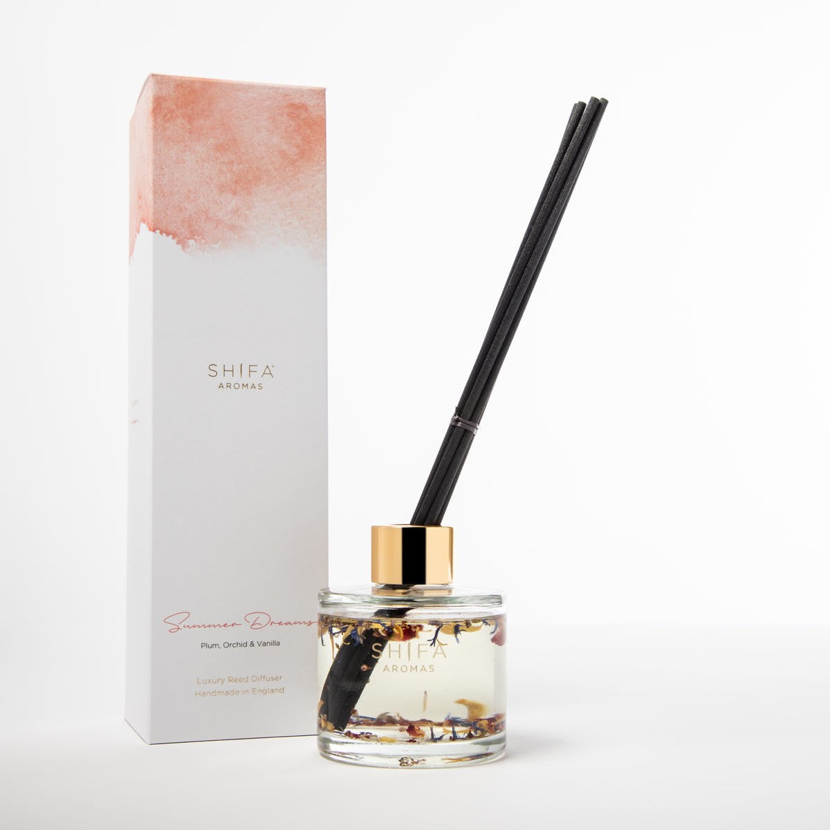 Summer Dreams reed diffuser by Ma'wa & Co – amber glass bottle with reed sticks beside gift box